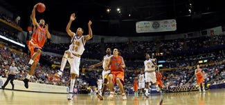 Florida's Taurean Green (11) drives to the basket as Louisiana State's Garrett Temple (14) defends in the second half of a semifinal game at the 2006 Southeastern Conference basketball tournament, Saturday, March 11, 2006, at the Gaylord Entertainment Center in Nashville, Tenn. Florida beat LSU 81-65.