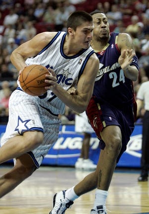Magic center Darko Milicic drives to the basket against Cleveland forward Donyell Marshall during the first half Friday. Milicic scored 11 points as the Magic won, 102-73.
