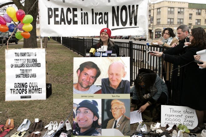 Christian Peacemaker Teams' co-director Carol Rose stands in front of a poster showing members of the Chicago-based group: James Loney, top left, Tom Fox, Harmeet Singh Sooden, bottom left, and Norman Kember, bottom right, during a news conference Thursday in Chicago.