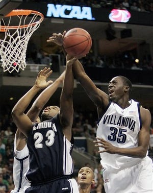 Villanova's Curtis Sumpter (35) blocks a shot by Monmouth's Marques Alston (23) during the first half of their NCAA first round college basketball game, Friday, March 17, 2006, in Philadelphia. Defending at left is Villanova's Will Sheridan.