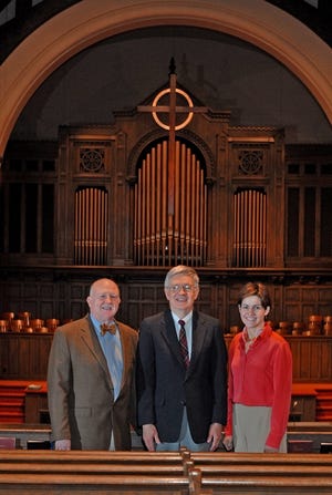 From left, the Revs. Larry Bates, Dr. Harry Daniel and Julie Thompson stand in the sanctuary at First

Presbyterian Church in Spartanburg. The new Celtic cross (in background above pulpit) was built by Dr. Auburn Woods from Honduran mahogany.