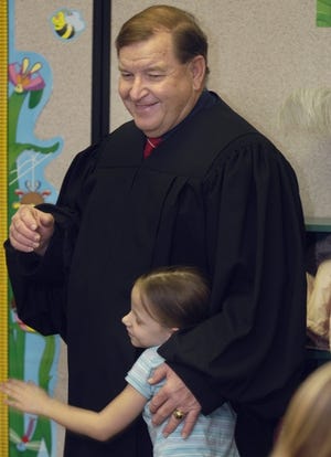 Judge Johnny Morrow came to Cowpens Elementary School to encourage

education and talk about the legal system. Here, Morrow gets a hug from Katlyn Owens, 7, who wanted to thank the judge for visiting the class.