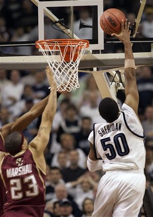 Villanova's Will Sheridan, right, goes up against Boston Colllege's Sean Marshall to score the winning basket in Villanova's 60-59 victory against Boston College during overtime in their NCAA Regional semifinal basketball game in Minneapolis, Friday, March 24, 2006.