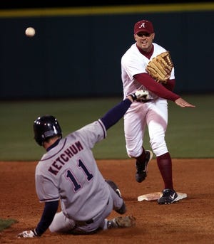 UA’s Evan Bush turns a double play as Ole Miss’ C.J. Ketchum is out at second.