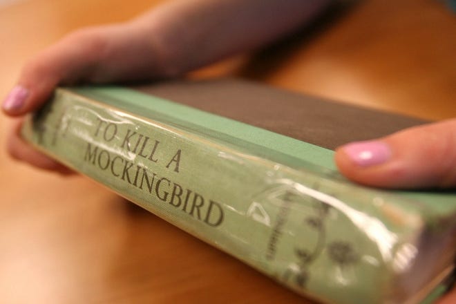 Caitlin McKnight holds her first-edition, autographed copy of Harper Lee’s “To Kill A Mocking-bird." Caitlin was a semi-finalist in an essay contest created in honor of the Pulitzer Prize-winning author.