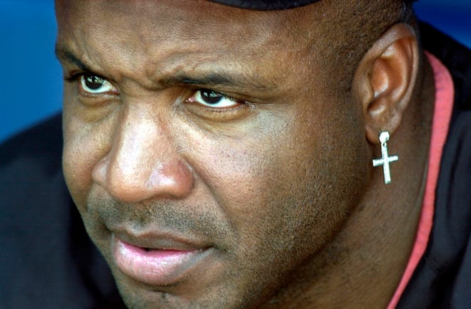 The San Francisco Giants' Barry Bonds watches from the dugout during team practice at Turner Field in Atlanta on Oct. 1, 2002. The book “Game of Shadows," written by two San Francisco Chronicle reporters about Barry Bonds, alleges that he and other superstars used steroids to enhance their performance.