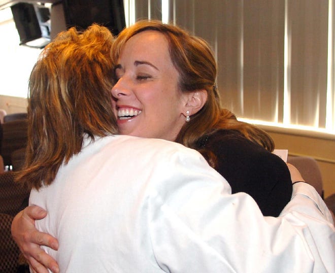 Georgianna Lopez, a case manager at Pocono Medical Center, left, gives Dr. Colleen Cahill a hug at the hospital Thursday. Dr. Cahill was one of two doctors named doctor of the year by the hospital.