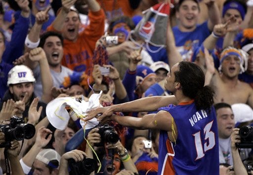 Joakim Noah celebrates with the crowd after his team beat UCLA 73-57 in the Final Four national championship basketball game in Indianapolis, Monday April 3, 2006.