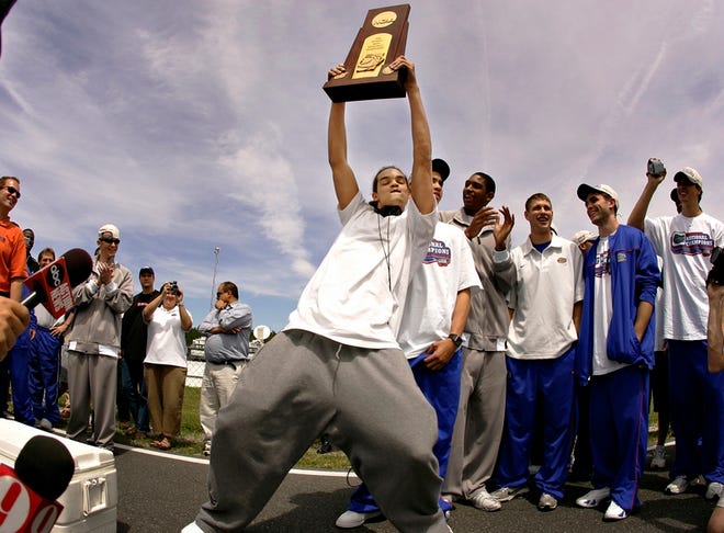 Florida's Joakim Noah dances with the 2006 National Championship trophy Tuesday at the Gainesville Raceway.
