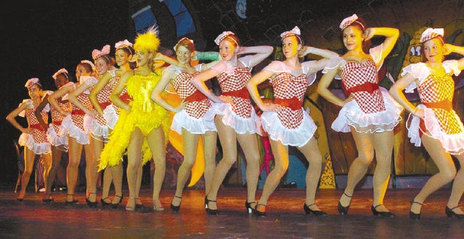 Ashley Sumner plays Miss Adelaide (center, in yellow), one of the major ‘dolls' in ‘Guys and Dolls,' performed by Stroudsburg High School students