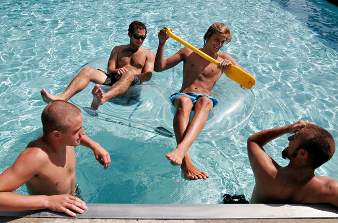 University of Florida freshmen Eric Gatch, clockwise from left, Daniel Olivero, Brent Moser and Matt Banta put off studying for finals to spend time relaxing at UF's Broward Pool on Monday.