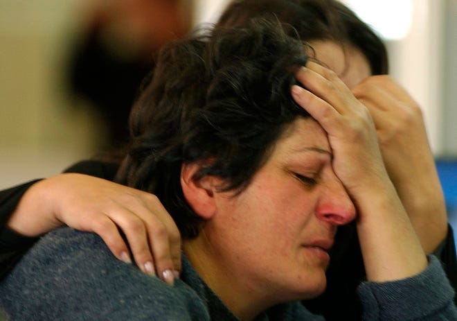 An unidentified relative of a passenger killed in Wednesday's plane crash reacts at Zvartnots Airport near Yerevan, Armenia, on Wednesday.