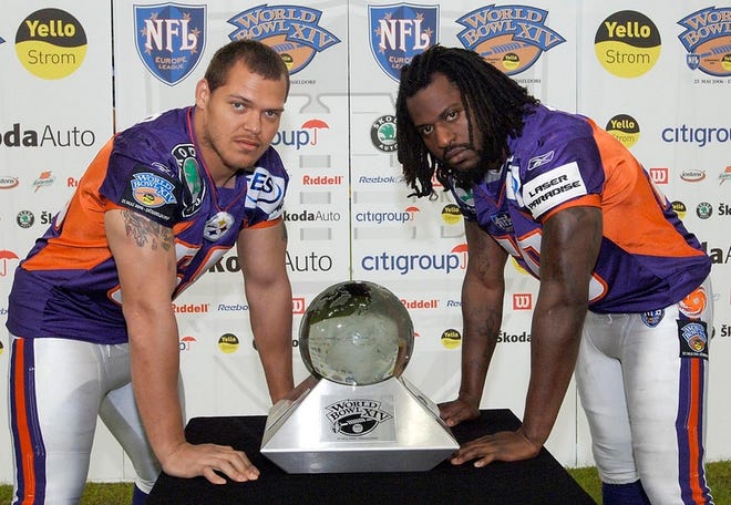 Former Gators Matt Farrior, left, and Travis Harris stand with the NFL Europe World Bowl trophy in Dusseldorf, Germany.