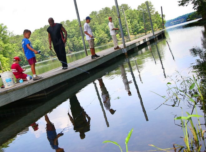 From left, Chris Largin, 11; Bradley Constant, 7; William Constant Sr.; Michael Constant, 12; and William Constant Jr., 13, spend the afternoon fishing at the Lake Tuscaloosa boat landing on New Watermelon Road on Friday.