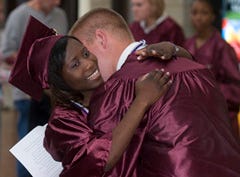 Salutatorian Woodlyne Celin of Harwich gets a hug from Justin Clifford of Yarmouth before graduation, during which she reminded classmates of the many choices ahead.