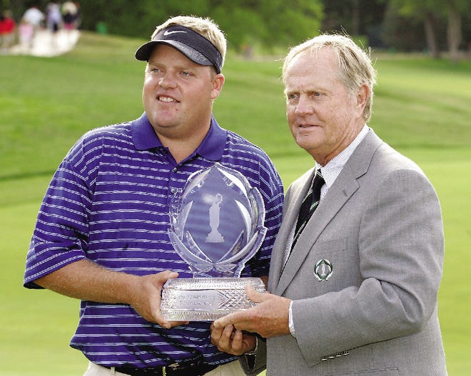 Carl Pettersson,left, of Sweden receives a trophy from Jack Nicklaus after Petterson won the Memorial golf tournament Sunday, June 4, 2006 at the Muirfield Village Golf Club in Dublin, Ohio.