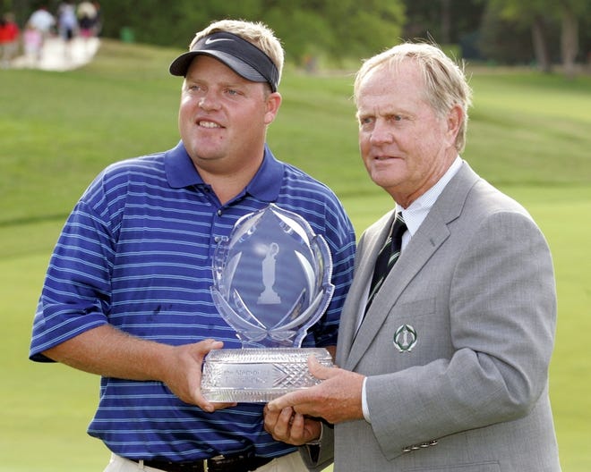 Carl Pettersson, left, receives a trophy from Jack Nicklaus after winning the Memorial golf tournament in Dublin, Ohio.