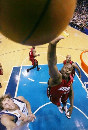 Miami's Shaquilee O'Neal reaches for a rebound as Dallas' Dirk Nowitzki looks on during Game 1.
