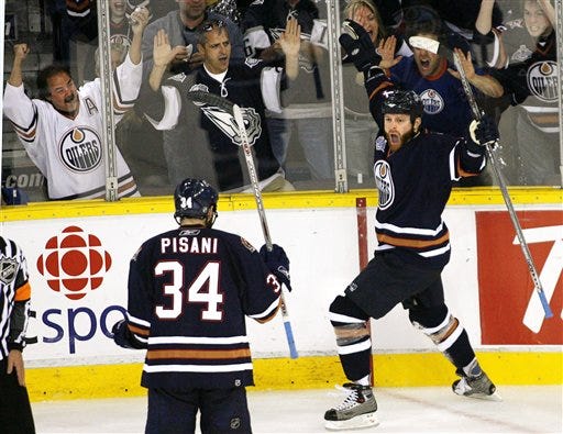 Edmonton Oilers' Raffi Torres, right , celebrates his second-period goal with teammate Fernando Pisani (34) against the Carolina Hurricanes during Game 6 of the NHL Stanley Cup Finals in hockey action in Edmonton, Canada, Saturday, June 17, 2006.