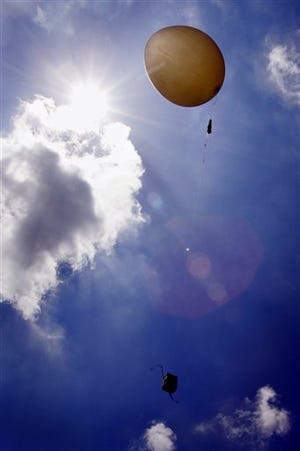 A weather balloon is released from the weather station at Cape Canaveral Air Force Station in Cape Canaveral, Fla., Wednesday, June 28, 2006. The balloon collects weather data for use in forecasting the weather for space launches. The crew of STS-121 is scheduled for launch aboard the Space Shuttle Discovery on Saturday, July 1, 2006.