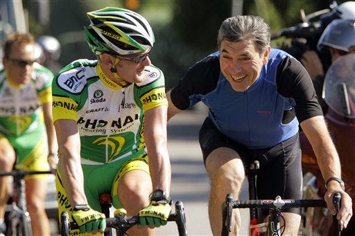 Floyd Landis of the US, left, cycles along with Belgian cycling legend Eddy Merckx during a training session of the Phonak team outside Gap, southeastern France, Monday, July 17, 2006, as riders of the 93rd Tour de France cycling race enjoy a rest day on Monday. The race resumes Tuesday with the 15th stage between Gap and L'Alpe d'Huez, French Alps. Merckx was visiting on Monday his son Axel Merckx, member of the team.