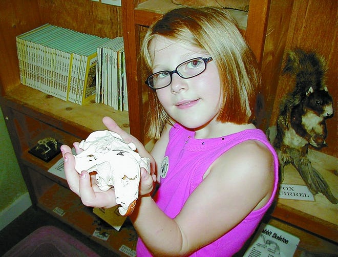 Little learner: 7-year-old Jessica Nemeth holds a beaver skull at the Oak Island Nature Center. Along with the Ocean Education Center, the Nature Center is run by Oak Island Parks and Recreation Department.