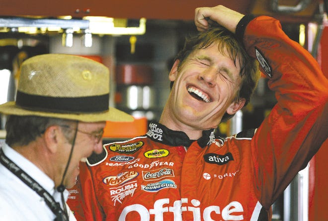 NASCAR driver Carl Edwards laughs with his car owner Jack Roush, left, during practice at the Pocono Raceway in Long Pond Friday.