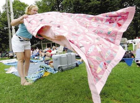 Carol Bridges, a resident of Exeter, gets her blanket ready for Sunday's folk festival.
Jamie Cohen