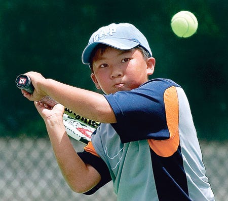 Peter Tong of Winter Park prepares to hit a backhand shot during a 12-and-under doubles match Sunday in the USTA Junior Team Tennis competition at Beerman Family Tennis Center in Lakeland.