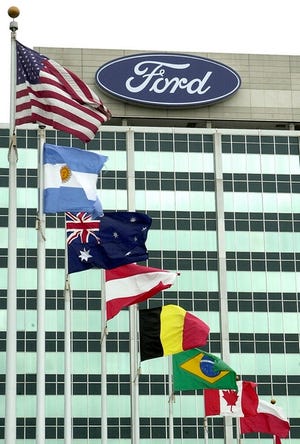 Ford Motor Company's logo is shown atop its world headquarters in Dearborn, Mich. Ford appears more likely to consider the possible sale of some operations as it works to accelerate the turnaround of its North American business, analysts say.