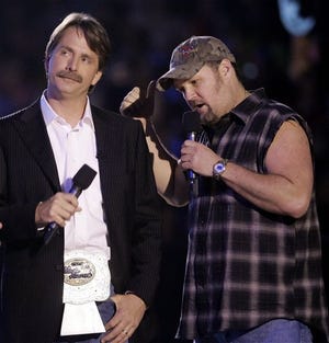 Dan Whitney, right, the comic who is better known as Larry the Cable Guy, performs with fellow comedian Jeff Foxworthy, left, during the CMT Music Awards Show April 11, 2005, in Nashville, Tenn. Whitney's comedy album, "The Right to Bare Arms," debuted at No. 1 and is approaching sales of 1 million copies. His success is no fluke, though, as comedy albums are doing well overall.