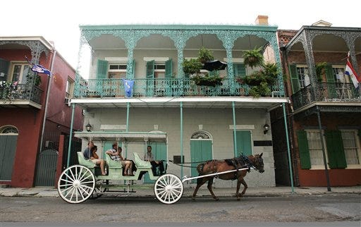 Tourists enjoy a carriage ride along Charters Street in the French Quarter in New Orleans.