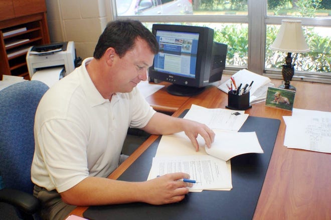 Newly promoted Principal Troy Sanford checks the schedule for the upcoming year.