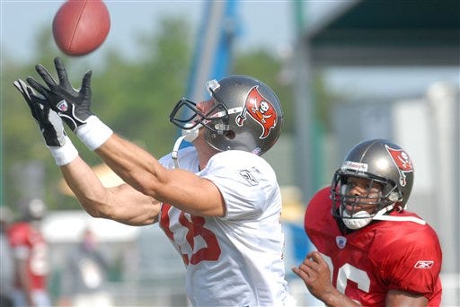 Tampa Bay Buccaneers wide receiver Chas Gessner, left, catches a pass in front of safety Will Allen during a morning session of football training camp in Lake Buena Vista, Fla., Wednesday, Aug. 2, 2006.