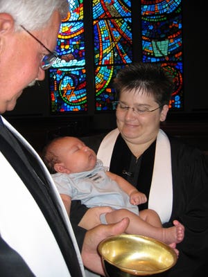 The Rev. Lois Caster baptizes two-month-old Frankie Mozingo as the newest member of White Bluff United Methodist Church.