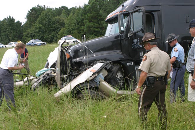 Police and fire officials investigate the wreckage in which 2 teenagers were killed on Tuesday morning at the intersection of Ga 196 and US17 in Liberty County near the Midway, Ga. Witnesses told police the driver Ashley Winkley failed to stop at a stop sign and was struck by a tractor trailer. Also killed in the accident was Dominique Gray.
