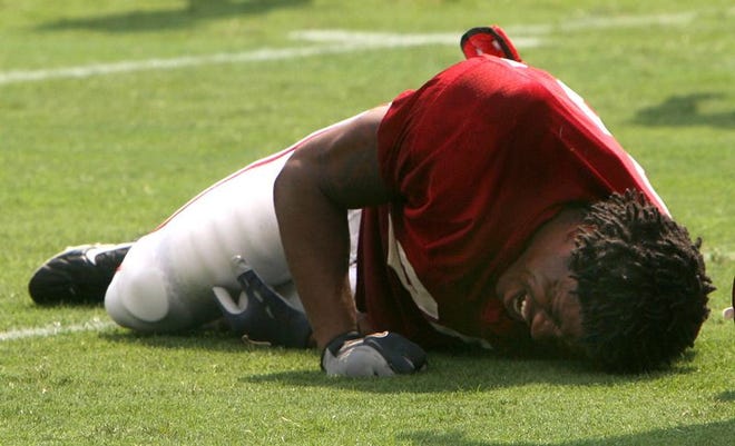 Alabama running back Glen Coffee grimaces in pain after injuring his knee during a scrimmage Monday.