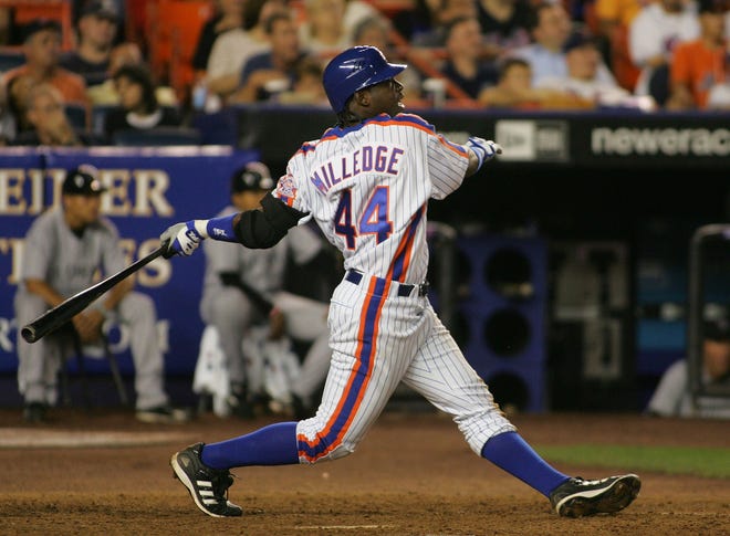 New York Mets' Lastings Milledge hits a solo home run against the Colorado Rockies during the eighth inning of their baseball game, Saturday, Aug. 19, 2006, at Shea Stadium in New York. The Mets defeated the Rockies, 7-4.