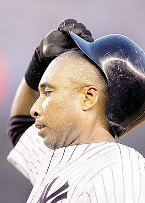 NEW YORK - JULY 18: Bernie Williams #51 of the New York Yankees takes off his helmet after he hit into a double play to end the third inning against the Seattle Mariners on July 18, 2006 at Yankee Stadium in the Bronx borough of New York City.