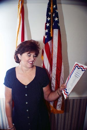 Tammy Moore, Mayor of Belleview, reads a flyer promoting the upcoming Freedom Walk, which will help commemorate the events of Sept. 11, 2001.