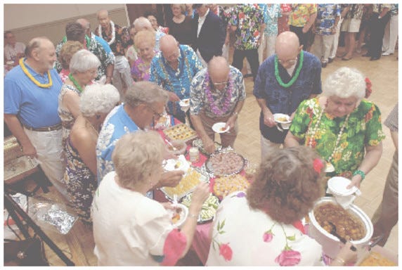 Members of the Stockton Singles seniors club line up for a potluck dinner before one of their weekly dances.