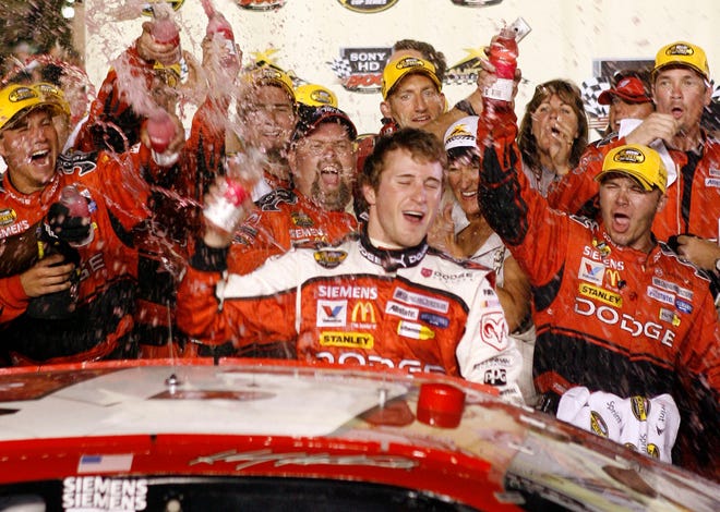 Kasey Kahne, center, celebrates with his crew after winning the NASCAR Nextel Cup Sony HD 500 auto race at the California Speedway in Fontana, Calif., on Sunday. (AP Photo/Matt Sayles)