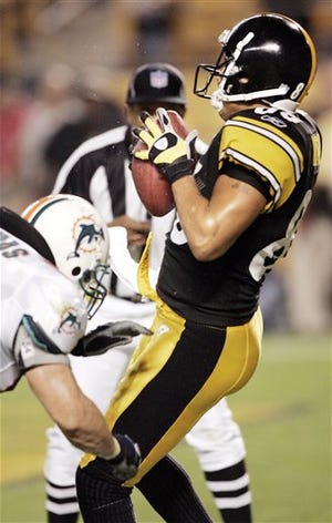 Pittsburgh Steelers wide receiver Hines Ward, right, makes a reception.