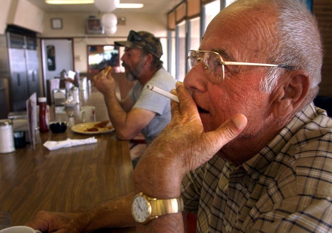 James Lord, 65, of Dublin, Ga., smokes a cigarette at the Smoker's Cafe.