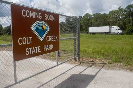 A sign marks the future entrance to Colt Creek State Park, which is scheduled to open this fall as Polk County’s second state park.