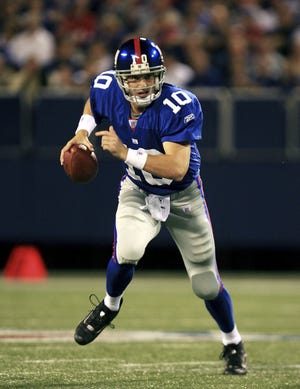 EAST RUTHERFORD, NJ - SEPTEMBER 10: Quarterback Eli Manning #10 of the New York Giants scrambles out of the pocket against the Indianapolis Colts during their game on September 10, 2006 at Giants Stadium in East Rutherford, New Jersey.