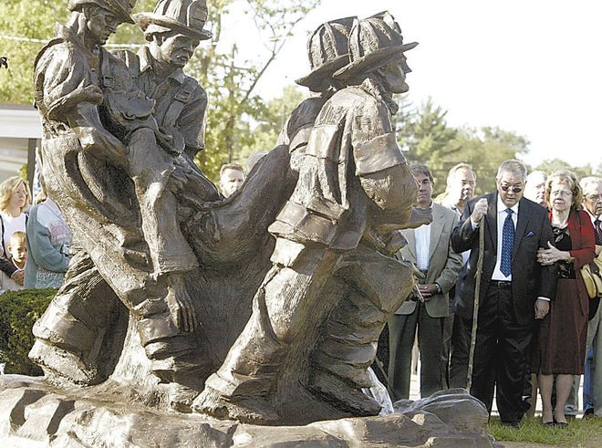 The benefactors to the City of Kingston who donated the statue at left, Clement Cody and his wife, Peggy Heinzer, right, are among the crowd at the unveiling ceremony at Fireman's Park in Kingston on the fifth anniversary of 9/11.