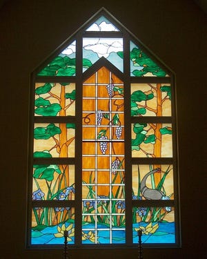 This is a stained-glass window in Hospice of Marion County's Legacy House chapel.