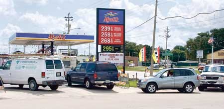 Vehicles form a line into the Mystik gas station on Havendale Boulevard in Winter Haven on Thursday. The store's owner claims to offer the best prices in town on gasoline, beer and cigarettes.