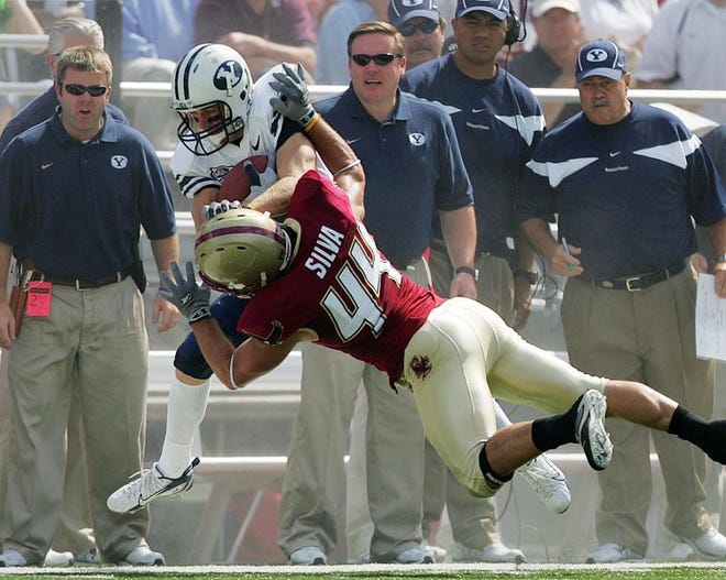 Boston College safety Jamie Silva forces BYU wide receiver Matt Allen out of bounds Saturday in front of BYU coaches.